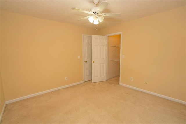 unfurnished room with carpet flooring and ceiling fan