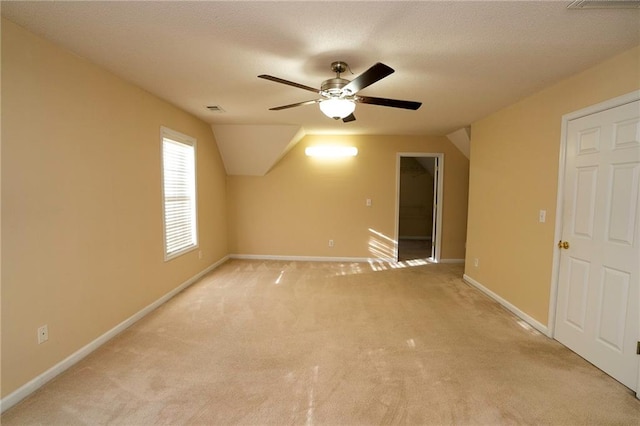 bonus room featuring ceiling fan, light colored carpet, and lofted ceiling