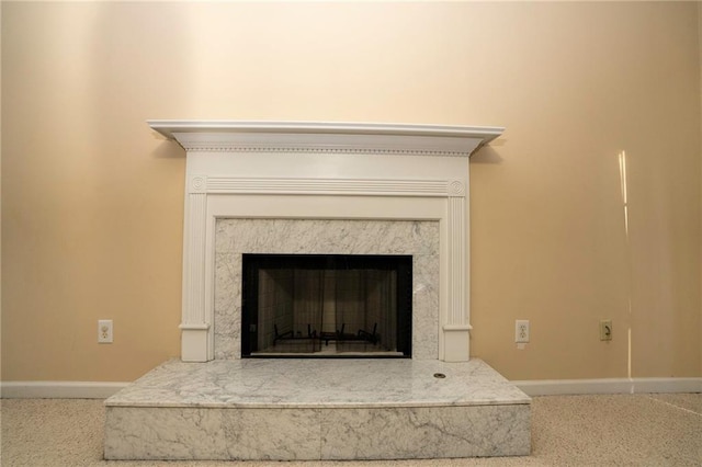 room details featuring a fireplace and carpet