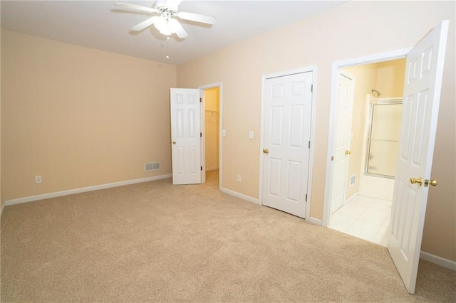 994 Rolling Forest Ln, Lilburn, GA 30047 - unfurnished bedroom with light carpet, baseboards, and ensuite bath