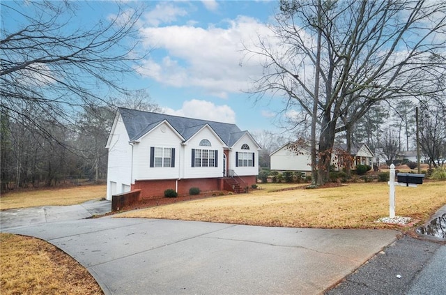 view of front of house with a garage and a front yard