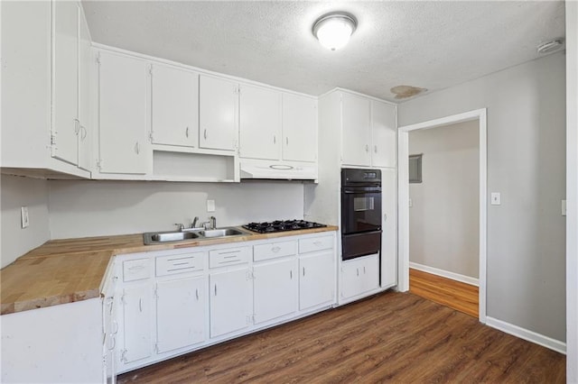 kitchen featuring dark wood-type flooring, a textured ceiling, white cabinetry, black appliances, and a sink