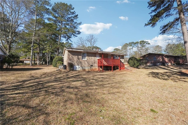 rear view of house featuring crawl space, a yard, and a deck