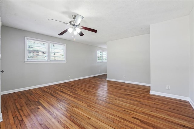 spare room featuring baseboards, ceiling fan, and hardwood / wood-style floors