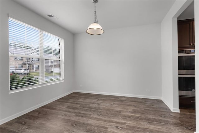 2537 Sori Dr, Buford, GA 30519 - unfurnished dining area featuring plenty of natural light, dark wood-type flooring, and baseboards