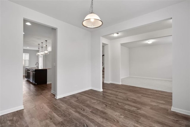 2537 Sori Dr, Buford, GA 30519 - spare room featuring baseboards, dark wood-style flooring, a sink, a chandelier, and recessed lighting