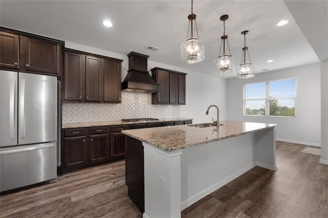 2537 Sori Dr, Buford, GA 30519 - kitchen with freestanding refrigerator, custom exhaust hood, a sink, black gas stovetop, and dark wood-style flooring