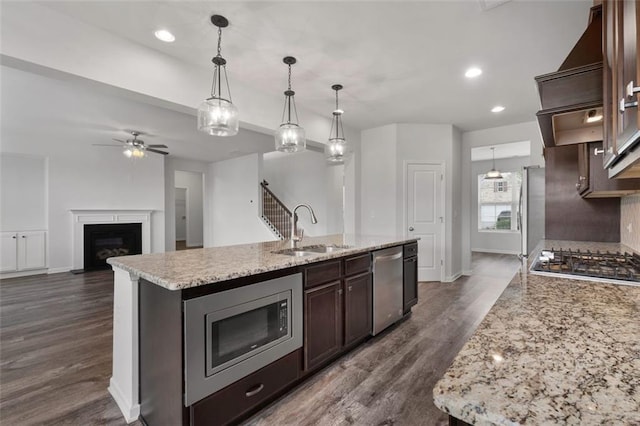 2537 Sori Dr, Buford, GA 30519 - kitchen with a sink, stainless steel appliances, dark brown cabinets, a ceiling fan, and dark wood-type flooring