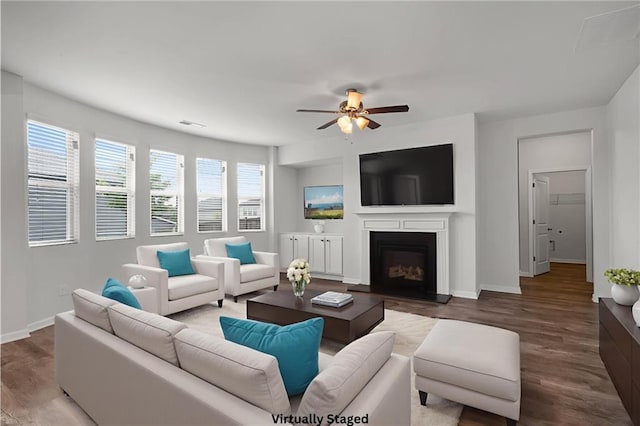 2537 Sori Dr, Buford, GA 30519 - living area with wood finished floors, ceiling fan, baseboards, and a fireplace with raised hearth