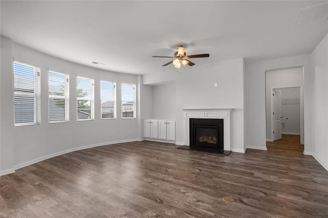 2537 Sori Dr, Buford, GA 30519 - unfurnished living room with dark wood finished floors, ceiling fan, a fireplace with raised hearth, and baseboards