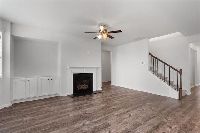 2537 Sori Dr, Buford, GA 30519 - unfurnished living room featuring wood finished floors, ceiling fan, stairs, a glass covered fireplace, and baseboards