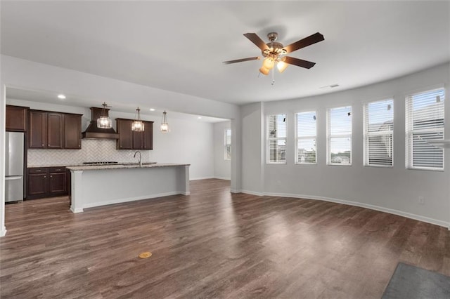 2537 Sori Dr, Buford, GA 30519 - unfurnished living room with healthy amount of natural light, a ceiling fan, and dark wood-style flooring