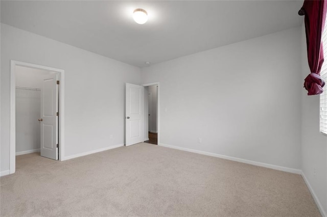 2537 Sori Dr, Buford, GA 30519 - unfurnished bedroom featuring carpet flooring, a walk in closet, baseboards, and a closet