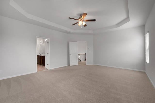 2537 Sori Dr, Buford, GA 30519 - unfurnished bedroom featuring a tray ceiling, light carpet, baseboards, and ensuite bath