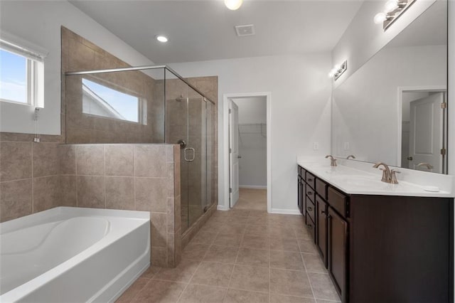2537 Sori Dr, Buford, GA 30519 - full bath featuring a bath, double vanity, a stall shower, tile patterned floors, and a walk in closet