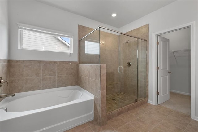 2537 Sori Dr, Buford, GA 30519 - bathroom featuring a garden tub, a stall shower, a walk in closet, and tile patterned flooring