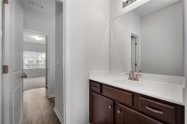 2537 Sori Dr, Buford, GA 30519 - bathroom featuring vanity, baseboards, and wood finished floors