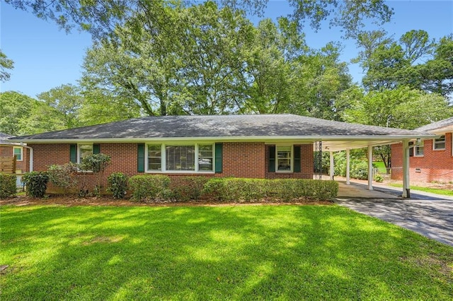 739 Pinehill Dr SE, Smyrna, GA 30080 - view of front of home with driveway, a front yard, brick siding, and a carport