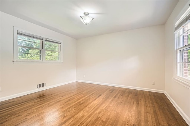 739 Pinehill Dr SE, Smyrna, GA 30080 - empty room with wood finished floors and baseboards