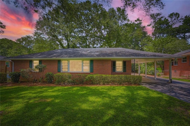 739 Pinehill Dr SE, Smyrna, GA 30080 - view of front of house with asphalt driveway, brick siding, a front yard, and an attached carport