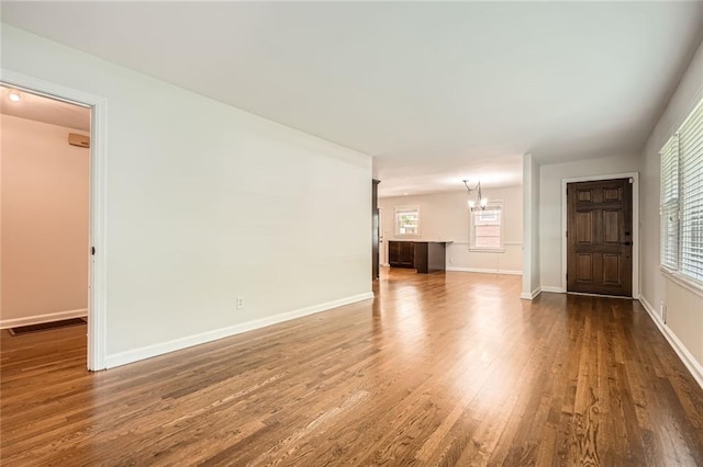 739 Pinehill Dr SE, Smyrna, GA 30080 - unfurnished living room featuring dark wood-style flooring and a chandelier