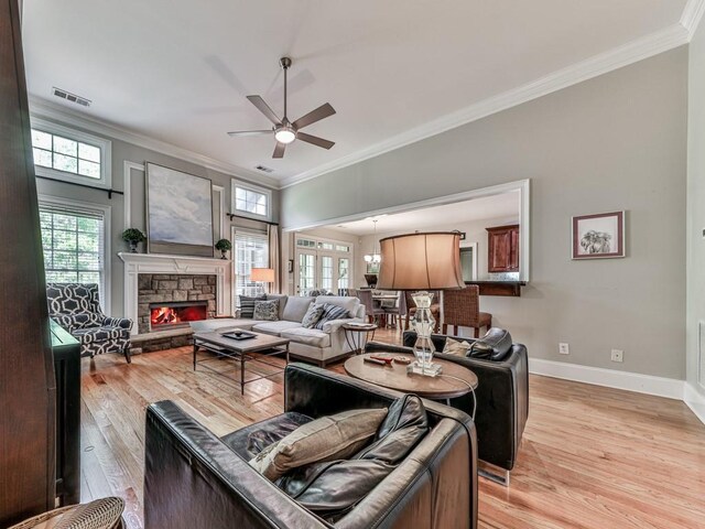 1076 Pinyan Ln, Canton, GA 30115 - living room featuring crown molding, ceiling fan, healthy amount of natural light, and light wood-type flooring