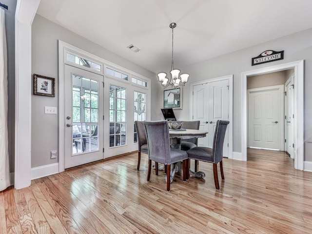 1076 Pinyan Ln, Canton, GA 30115 - dining area with light wood-type flooring and a chandelier