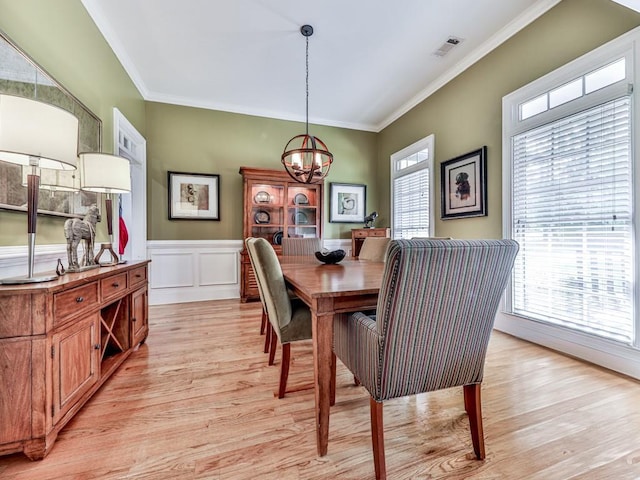 1076 Pinyan Ln, Canton, GA 30115 - dining space with light wood finished floors, a chandelier, crown molding, and a wainscoted wall