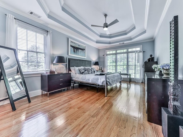 1076 Pinyan Ln, Canton, GA 30115 - bedroom featuring wood finished floors, a tray ceiling, and crown molding