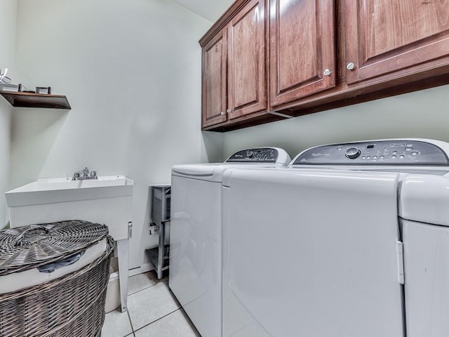 1076 Pinyan Ln, Canton, GA 30115 - laundry room with washing machine and dryer, cabinet space, and light tile patterned floors