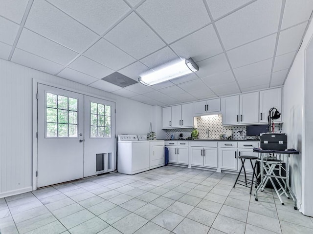 1076 Pinyan Ln, Canton, GA 30115 - kitchen with washer and clothes dryer, dark countertops, light tile patterned floors, a paneled ceiling, and white cabinetry