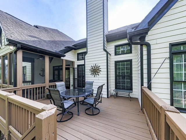 1076 Pinyan Ln, Canton, GA 30115 - wooden deck with outdoor dining space and a sunroom