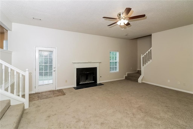 137 Legend Creek Dr, Canton, GA 30114 - unfurnished living room featuring stairs, carpet, a textured ceiling, healthy amount of natural light, and a ceiling fan