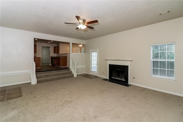 137 Legend Creek Dr, Canton, GA 30114 - unfurnished living room with a textured ceiling, ceiling fan, carpet floors, stairs, and baseboards
