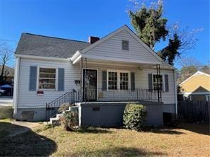 view of front of property with covered porch and a front yard