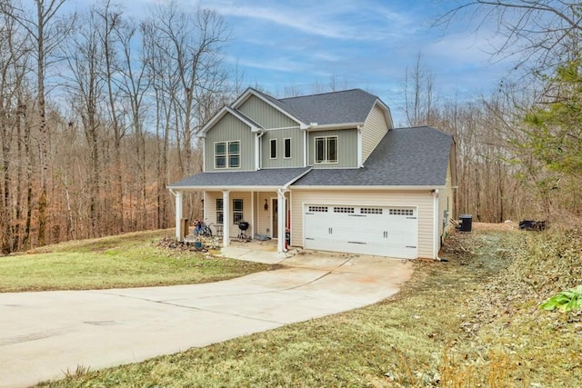 view of front of home featuring a porch, central AC, a front lawn, and a garage