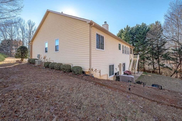 view of side of property with central AC