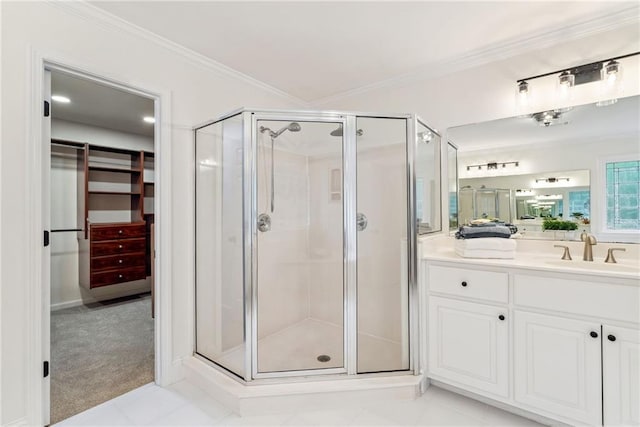 bathroom with vanity, ornamental molding, and a shower stall