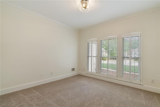 unfurnished room with crown molding, baseboards, carpet flooring, and visible vents