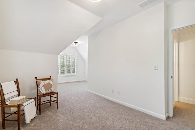 sitting room with baseboards, carpet, vaulted ceiling, and visible vents