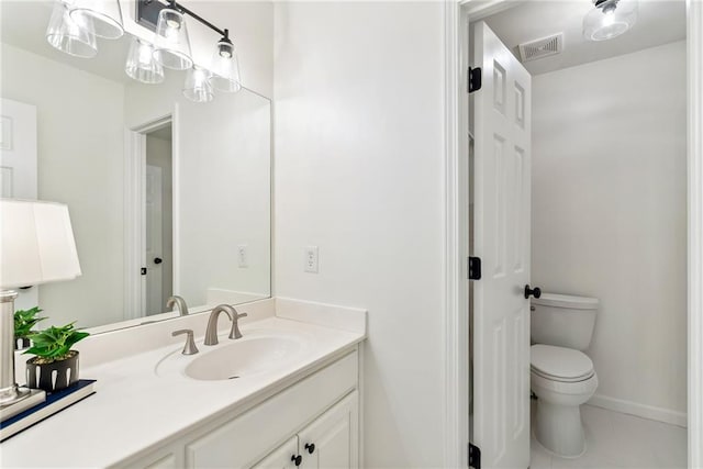 bathroom featuring visible vents, tile patterned flooring, vanity, baseboards, and toilet