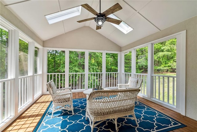 sunroom featuring wood finished floors and vaulted ceiling with skylight