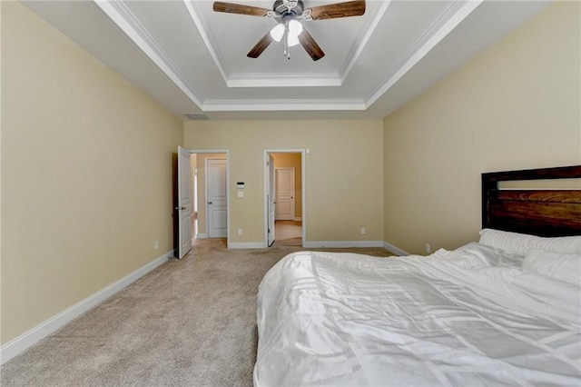 bedroom with crown molding, ceiling fan, a raised ceiling, and light carpet