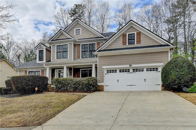 craftsman-style house with a garage and a front lawn