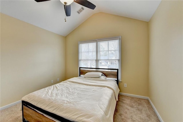 bedroom with vaulted ceiling, light colored carpet, and ceiling fan