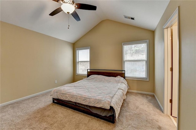 bedroom with ceiling fan, lofted ceiling, and light carpet