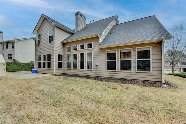 back of property featuring a patio and a yard