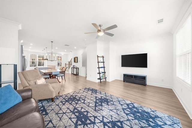 living room featuring hardwood / wood-style flooring and ceiling fan