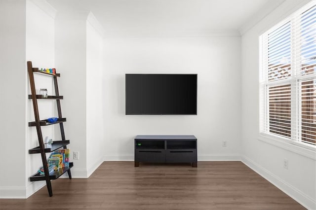 unfurnished living room with dark wood-type flooring and ornamental molding