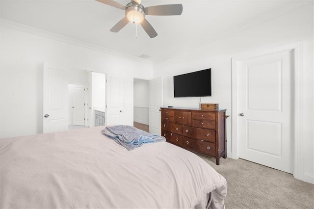 carpeted bedroom with crown molding, ensuite bathroom, and ceiling fan